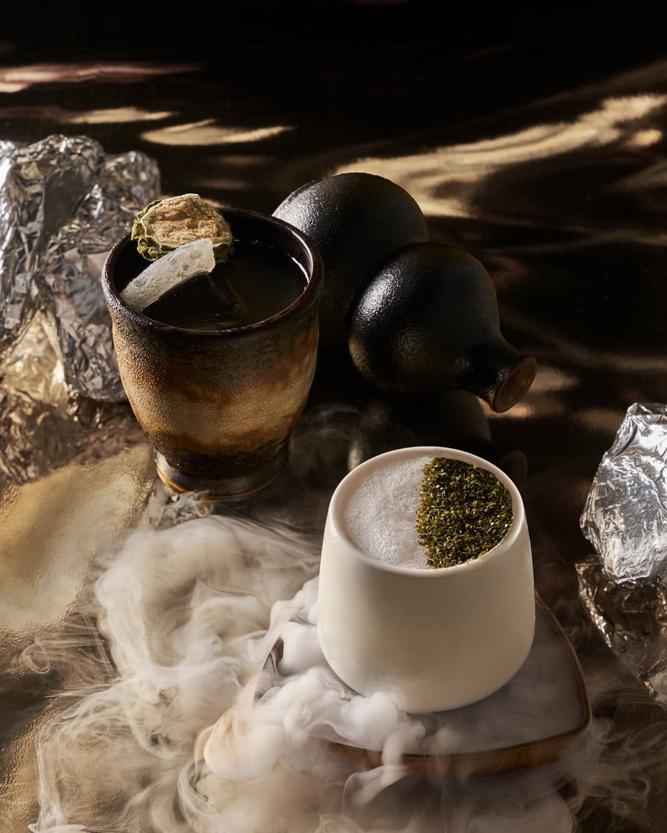 Two smoky Synthesis cocktails in ceramic and white cups